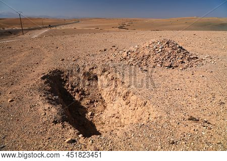 Shallow Grave In The Desert. Agafay Desert Near Marrakesh, Morocco.