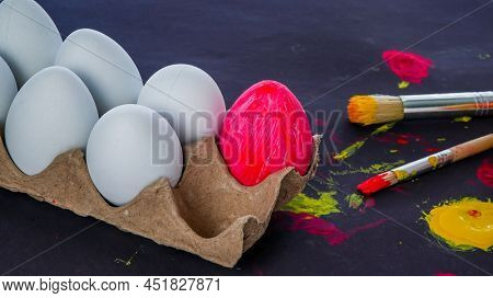 Easter eggs painting set up on black background with sopy space