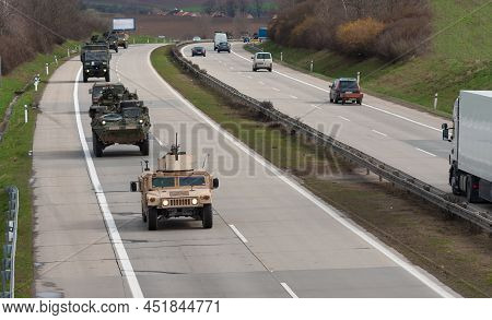 Us Army Military Convoy Passes  In Czech Republic. Strykers, Humvee, Wheeled Armored Vehicles Drive 