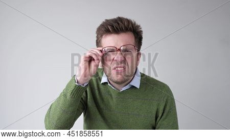 Curious Scrupulous Man Looks Attentively At One Point, Sees Something Strange Or .