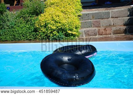 There Are Two Floating Tires In The Pool.