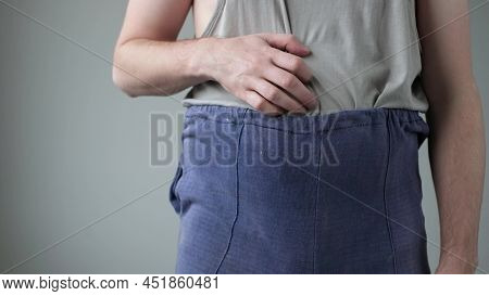 Badly Dressed Man Is Scratching His Belly