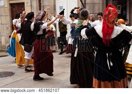 Vigo, Galicia, Spain, March 26 2022: Two Rows Of People Dancing A Linear Galician Dance At A Street 