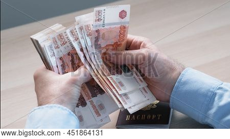 Close-up Of Hands Counting Five-thousandth Banknotes Of The Russian Ruble. Mens Hands Count Russian 