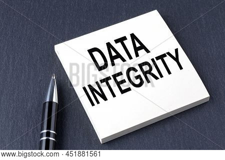 Data Integrity Text On Sticker With Pen On The Black Background