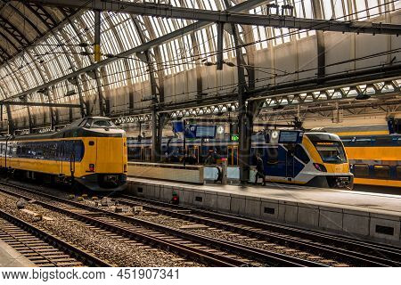 Amsterdam, Netherlands, March 2022. Dutch Train In The Landscape And In The Central Station