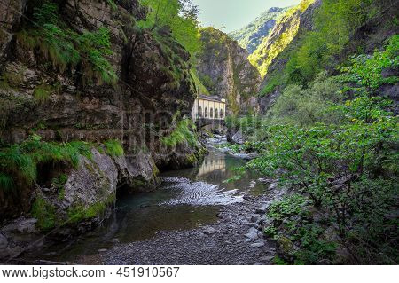 Mountain River In The Gorge Of Mountains Near The City Of San Pelegrino In Italy
