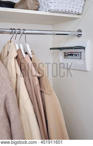 Automatic Fusein A Home Electrical Panel In The Closet With Clothes. Electricity Equipment In The Ap