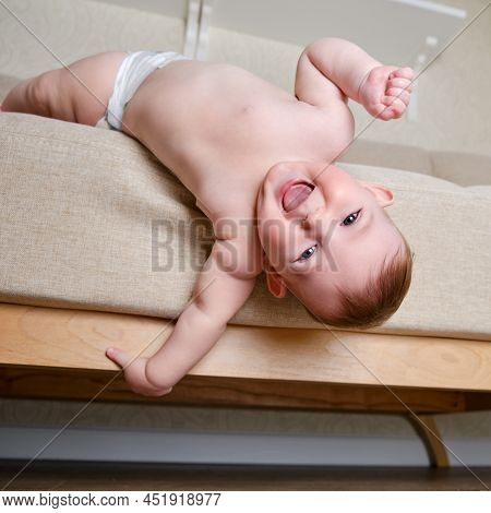 Infant Baby Falls Off The Sofa In The Home Living Room. Toddler Kid Gets Off The Bed. Problems With 