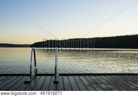 Handrails On The Wooden Swimming Pier And The Lake Saimaa Onthe Background, Ukonlinna Beach, Imatra,