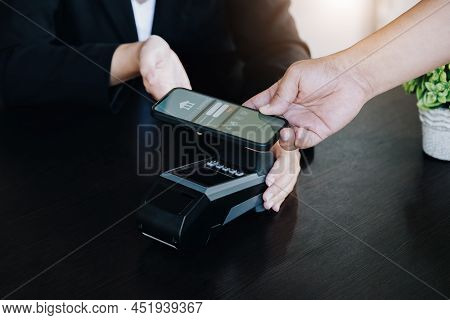 Payment Security Technology Concept And Service Fees, Employees Are Holding Electronic Card Machines