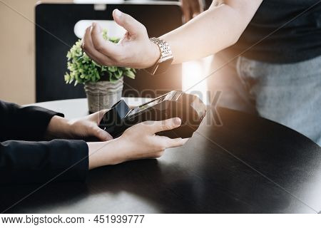 Payment Security Technology Concept And Service Fees, Employees Are Holding Electronic Card Machines