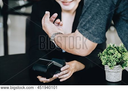 Payment Security Technology Concept And Service Fees, Employees Are Holding Electronic Card Machines