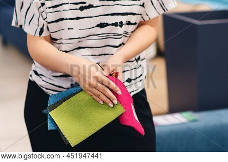 Woman Chooses The Colors And Patterns Of Upholstery Fabrics. Textile Industry Background. Tissue Cat