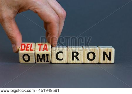 Covid-19 Omicron Or Deltacron Symbol. Doctor Turns Cubes And Changes The Word Omicron To Deltacron. 