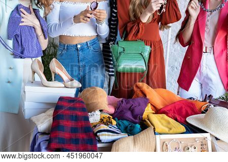 Young Women At Swap Party. Casual Clothes, Shoes, Hats, Bags, Jewellery. Idea Of Exchange Your Old W