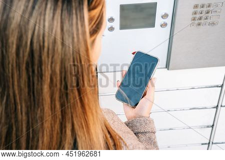 Automated Locker. Parcel Courier Box In Woman Hands At Post Delivery Automat Terminal. Courier Puts 