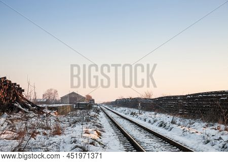 Railway Line In Winter, Covered In Snow, With Rails, Frozen, Neglected And Decaying In A Rural Train