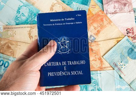 Hand Holding Brazilian Document Work And Social Security (carteira De Trabalho E Previdencia Social)