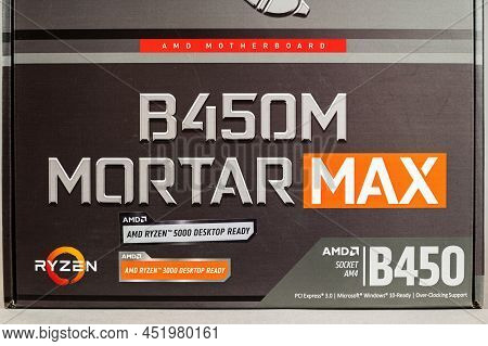 Msi B450 Mortal Max Motherboard Against A Gray Background. Black Box With The New Computer Hardware.