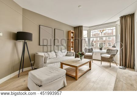 Spacious Living Room In A Casually Stere With Lots Of Lamps And Necessary Furniture