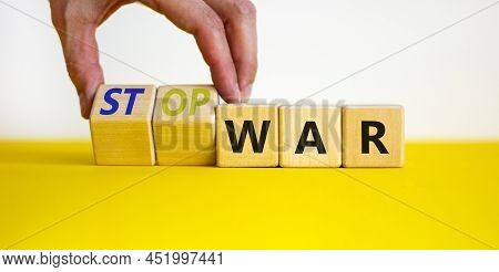Stop War Symbol. Businessman Turns Cubes And Changes Concept Words War To Stop War. Beautiful Yellow