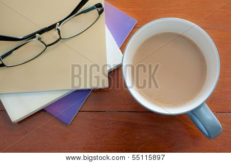 Coffee Cup And Stack Book Glasses On Red Wood Table