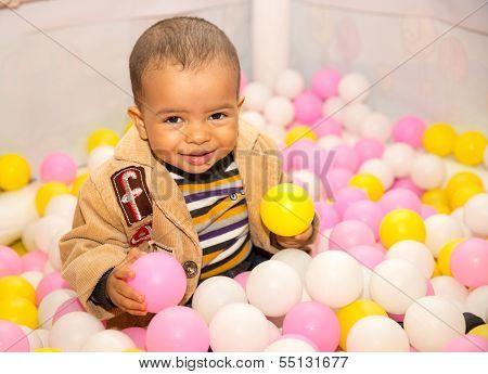 Happy Black Boy In Colored Balls