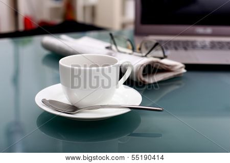 Image of business table with a cup of coffee and norebook