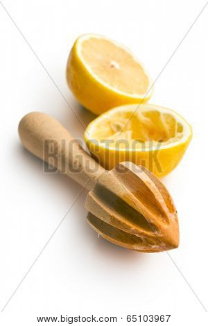squeezed lemon fruit and citrus reamer on white background