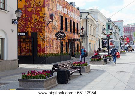 Buildings, Flower Beds, Benches And Walking People On Stoleshnikov Street In Moscow