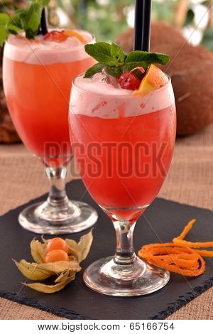 Fruit punch cocktail drink and fruits.