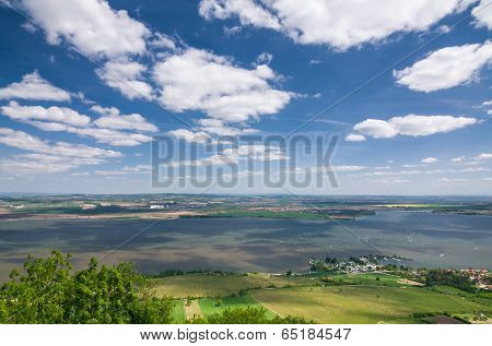 Spring Countryside With Lake, Fields And Blue Sky With Clouds
