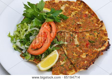 Homemade traditional Turkish meal pide stuffed with meat cheese,  and sauce isolated on white background