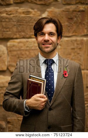 Smiling Bearded Schoolteacher In Museum Wearing Poppy