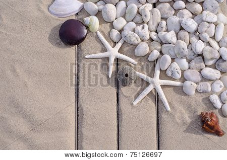 Top View Of  Starfishs And White Stone On Sand Background