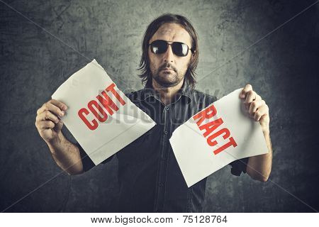 Man Tearing Apart Contract Document