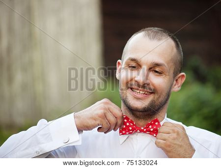 Handsome groom getting ready for wedding