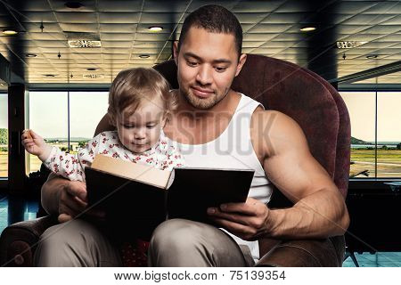 Father Reading Book To Daughter