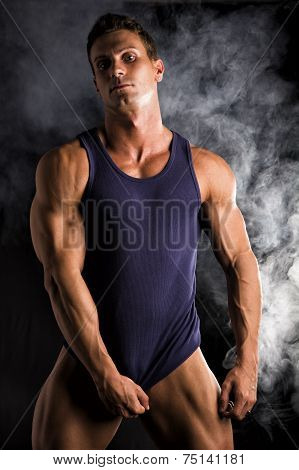 Young Athletic Man Pulling Down Tanktop On Ripped Muscular Torso