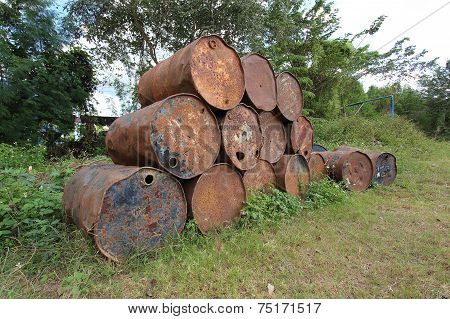 Old Rusty Metal Fuel Tanks Stacked In A Row