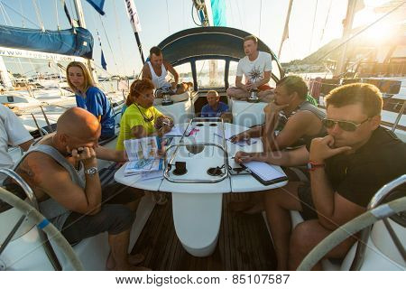 PATRAS, GREECE - CIRCA OCT, 2014: Unidentified sailors on skipper's briefing in the yacht wardroom during sailing regatta 12th Ellada Autumn 2014 among Greek island.