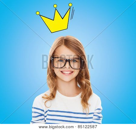 education, school, children and vision concept - smiling little girl with black eyeglasses over blue background with crown doodle