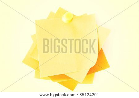 Yellow small memo attached with drawin pin.