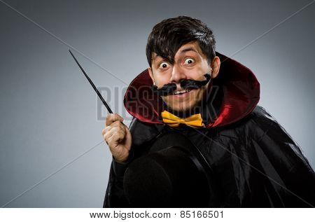 Funny magician man with wand and hat