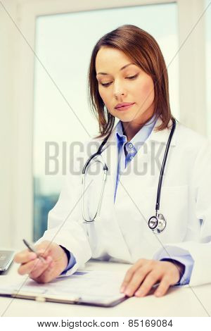 medicine and healthcare concept - busy doctor with laptop computer