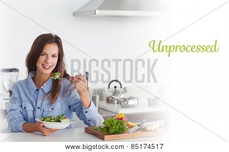 The word unprocessed against woman eating a vegetarian salad