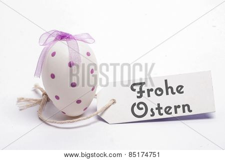 frohe ostern against white easter egg with blank tag
