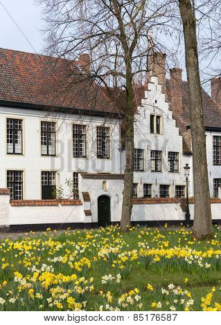 Medieval white houses of the beguinage of the famous city of Bruges in Flanders, Belgium