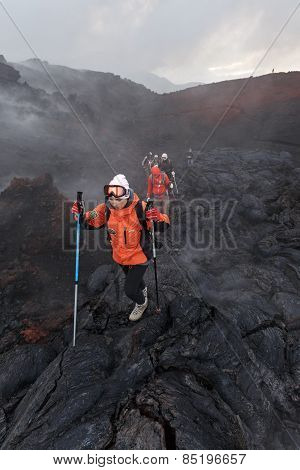 Group Of Tourists Hiking On The New Lava Field Eruption Tolbachik Volcano On Kamchatka. Russia